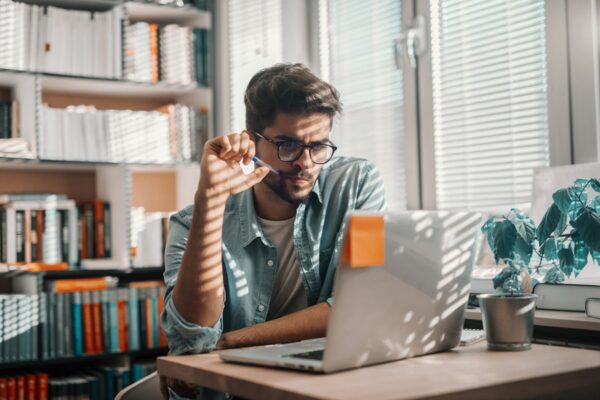 The image shows a marketer working on his laptop in Australia.