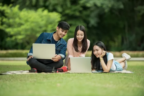 9 Easiest Countries for International Students to Get PR. 
Student are studying on the their laptops on the ground.